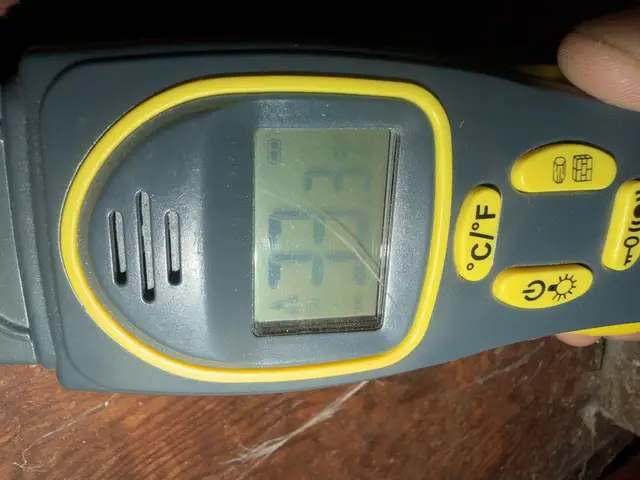 Close-up of the moisture meter display, taken on the dining-room laminate